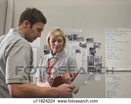 Picture - Factory Workers With Clipboards. Fotosearch