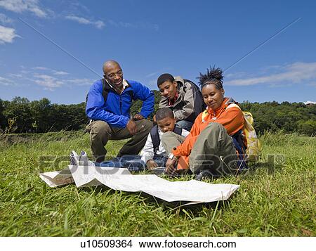 family hiking looking at map View Large Photo Image Picture - family hiking looking at map. Fotosearch