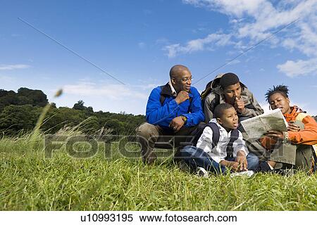 family hiking looking at map View Large Photo Image Stock Photography - family hiking looking at map. Fotosearch