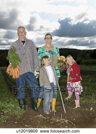 Family in a field View Large Photo Image Stock Photo - Family in a field. Fotosearch