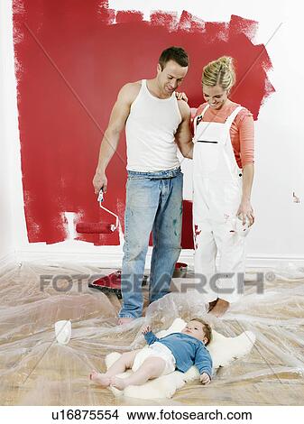 Family in front of newly painted wall View Large Photo Image Picture - Family in front of newly painted wall. Fotosearch