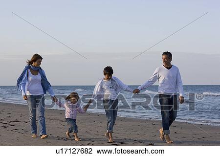 Stock Image - Family on the beach.. Fotosearch