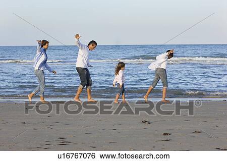 Stock Photograph - Family on the beach.. Fotosearch
