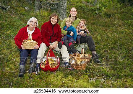 Family with mushroom baskets in forest View Large Photo Image Stock Photograph - Family with mushroom baskets in forest. Fotosearch