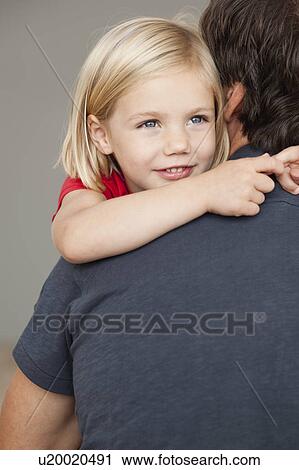 Stock Image - father and daughter hugging. Fotosearch