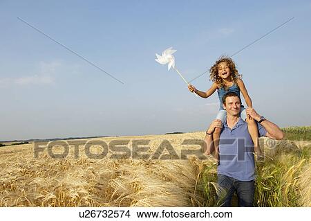 Father and daughter in a wheat field View Large Photo Image Picture - Father and daughter in a wheat field. Fotosearch