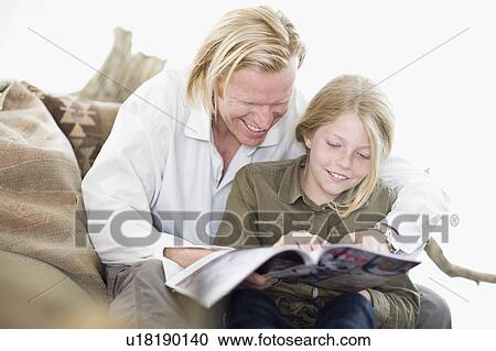 father and daughter reading a magazine View Large Photo Image Stock Image - father and daughter reading a magazine. Fotosearch