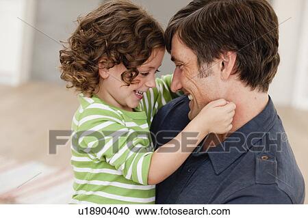 Stock Image - father and daughter snuggling. Fotosearch
