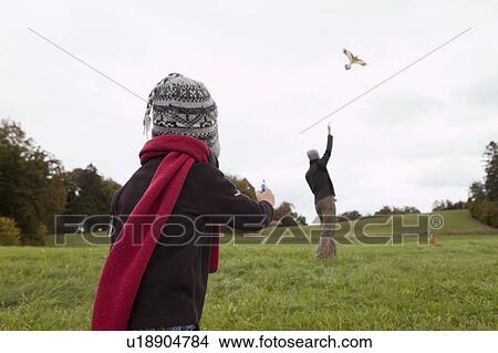 Picture - Father and son fly a kite. Fotosearch