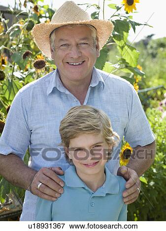 Father and son in a sunflower garden View Large Photo Image Stock Photo - Father and son in a sunflower garden. Fotosearch