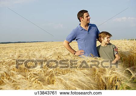 Stock Image - Father and son in a wheat field. Fotosearch