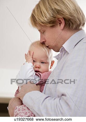 father comforting crying baby View Large Photo Image Stock Photo - father comforting crying baby. Fotosearch
