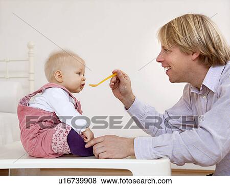 father feeding baby View Large Photo Image Stock Photo - father feeding baby. Fotosearch