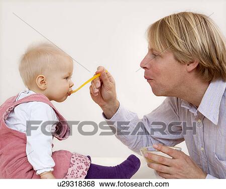 father feeding baby View Large Photo Image Stock Photo - father feeding baby. Fotosearch