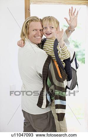 Stock Image - father getting his son to school. Fotosearch
