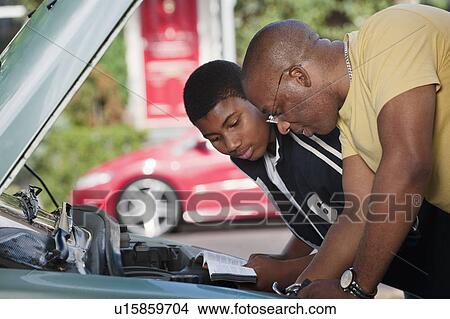 father & son working on car engine View Large Photo Image Picture - father & son working on car engine. Fotosearch
