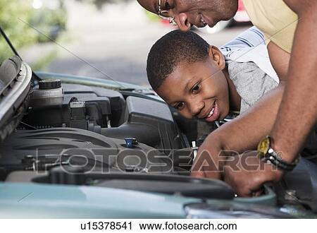 father & son working on car engine View Large Photo Image Stock Image - father & son working on car engine. Fotosearch