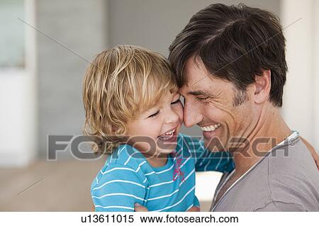 Stock Photography - father tickling son. Fotosearch