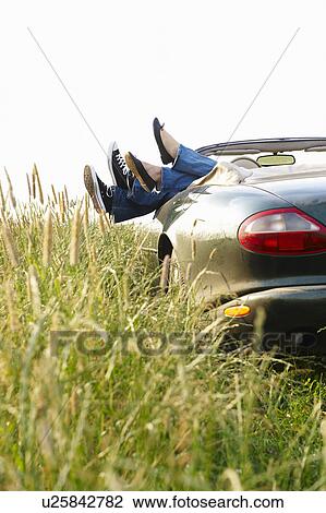 Feet of a couple sticking up from car View Large Photo Image Stock Image - Feet of a couple sticking up from car. Fotosearch