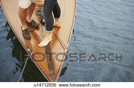 Feet of middle aged couple on old boat View Large Photo Image Stock Photography - Feet of middle aged couple on old boat. Fotosearch