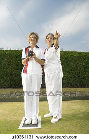 Stock Image - female bowlers on green. Fotosearch