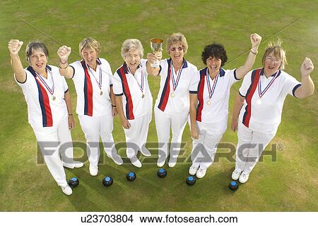 Picture - female bowls team and trophy. Fotosearch