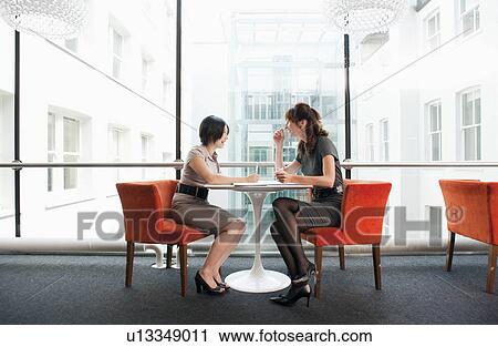 Stock Image - Female couple working at a restaurant. Fotosearch