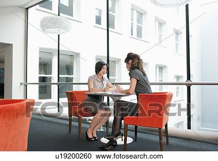 Stock Image - Female couple working at a restaurant. Fotosearch