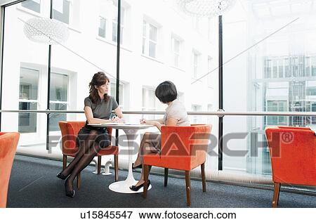 Stock Photo - Female couple working at a restaurant. Fotosearch