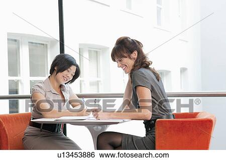 Female couple working at a restaurant View Large Photo Image Stock Photograph - Female couple working at a restaurant. Fotosearch
