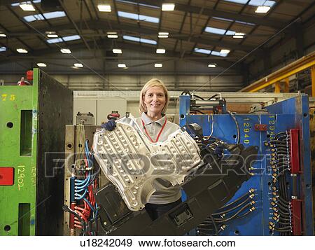 Female Factory Worker Holding Part View Large Photo Image Stock Photo - Female Factory Worker Holding Part. Fotosearch