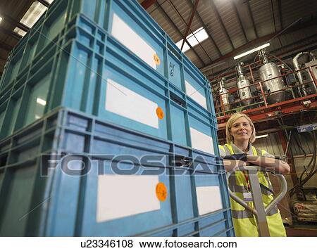 Stock Photo - Female Factory Worker With Boxes. Fotosearch