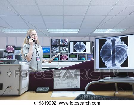 Stock Image - Female Fusion Scientist On Telephone. Fotosearch