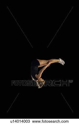 female gymnast upside down mid flight View Large Photo Image Stock Image - female gymnast upside down mid flight. Fotosearch