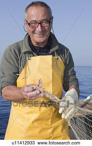 fisherman on boat, trawling, smiling View Large Photo Image Stock Image - fisherman on boat, trawling, smiling. Fotosearch