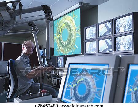Stock Image - Fusion Reactor Scientist At Work. Fotosearch