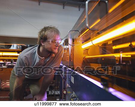Stock Photo - Fusion Reactor Scientist With Laser. Fotosearch