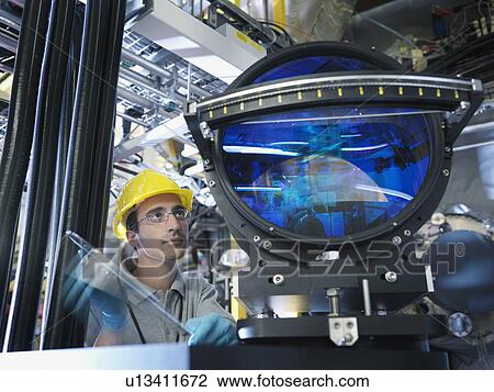Stock Image - Fusion Reactor Scientist With Lens. Fotosearch