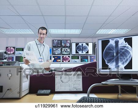 Stock Image - Fusion Reactor Scientist With Screens. Fotosearch