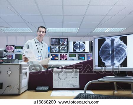 Stock Image - Fusion Reactor Scientist With Screens. Fotosearch