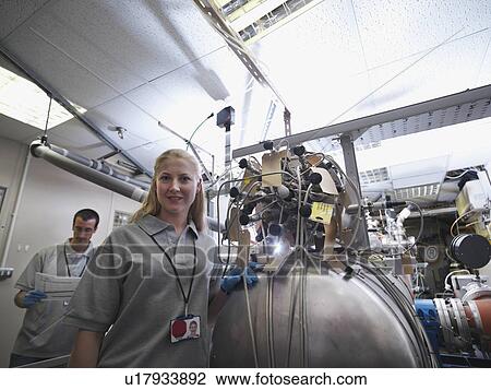 Stock Image - Fusion Reactor Scientists At Work. Fotosearch