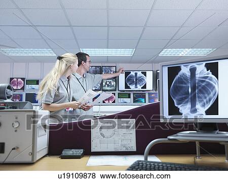 Stock Photo - Fusion Reactor Scientists With Screens. Fotosearch