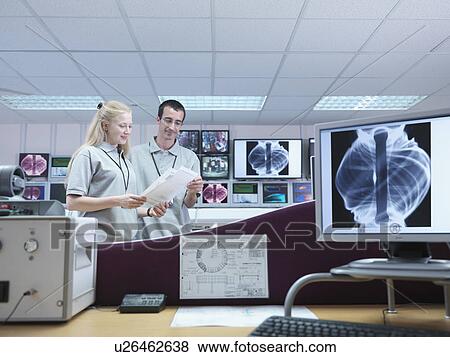 Stock Photo - Fusion Reactor Scientists With Screens. Fotosearch
