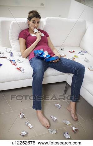 Stock Photograph - girl addicted to chocolate bars. Fotosearch