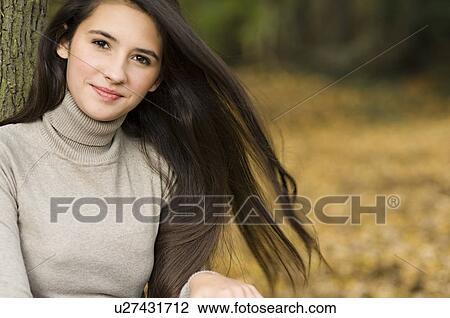 girl against a tree View Large Photo Image Stock Image - girl against a tree. Fotosearch