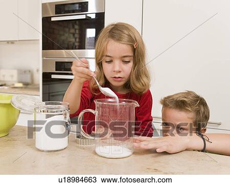 girl and boy measuring sugar View Large Photo Image Stock Image - girl and boy measuring sugar. Fotosearch