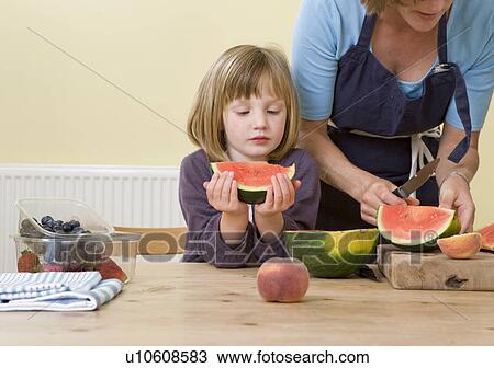 girl and mother with watermelon slices View Large Photo Image Stock Image - girl and mother with watermelon slices. Fotosearch