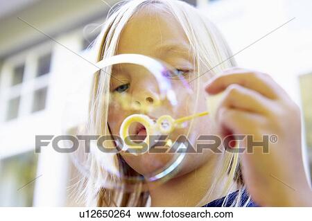 Girl blowing bubbles View Large Photo Image Picture - Girl blowing bubbles. Fotosearch