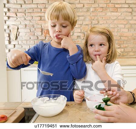 girl, boy tasting baking ingredients View Large Photo Image Stock Image - girl, boy tasting baking ingredients. Fotosearch