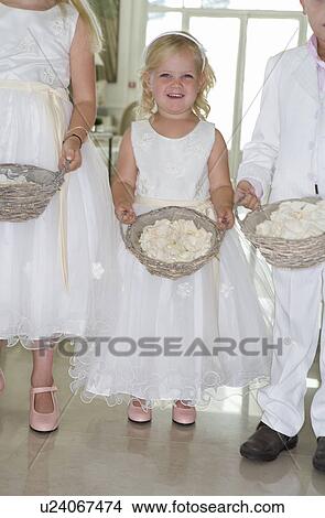 Picture - girl bridesmaid with rose petals. Fotosearch